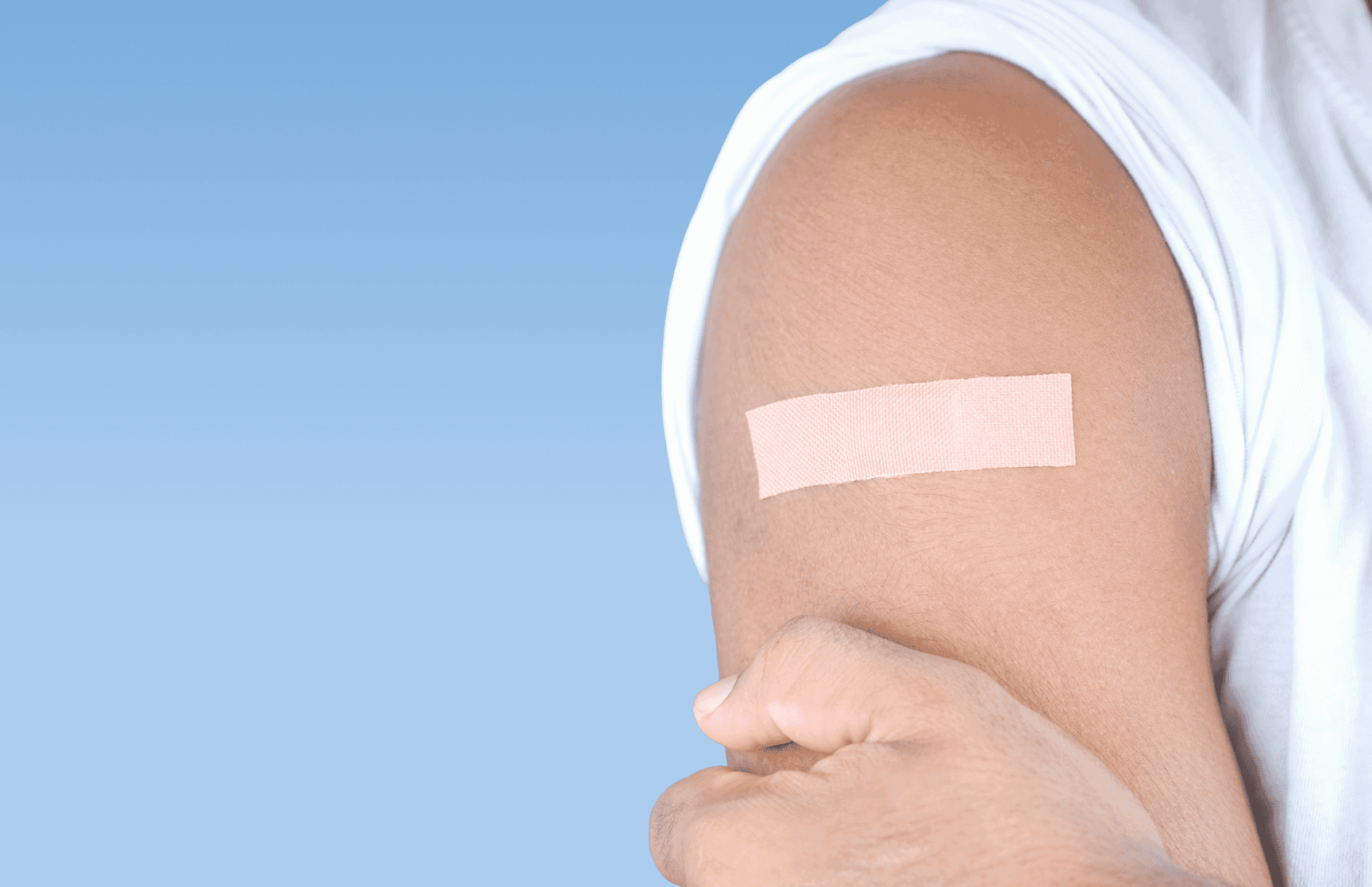 A patient with a bandage after receiving a vaccine